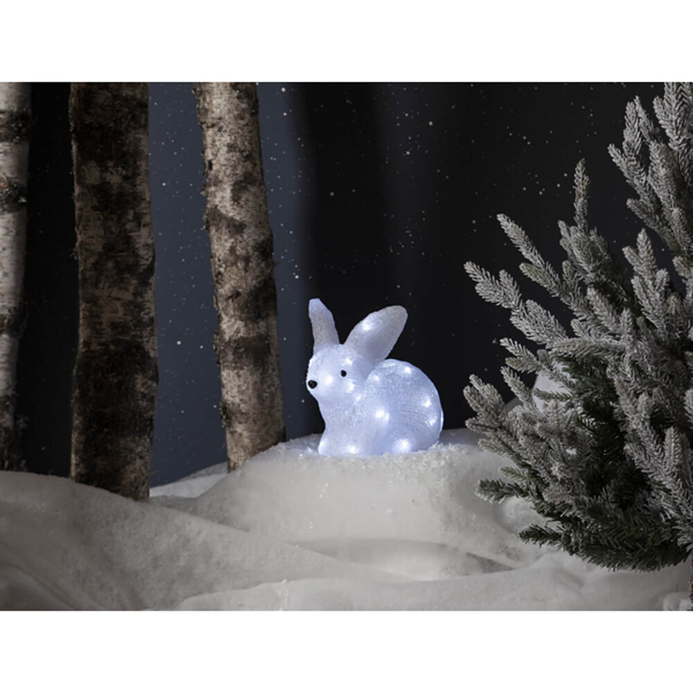Charmante, weiß leuchtende Acrylfigur in Form eines liegenden Kaninchens von Star Trading